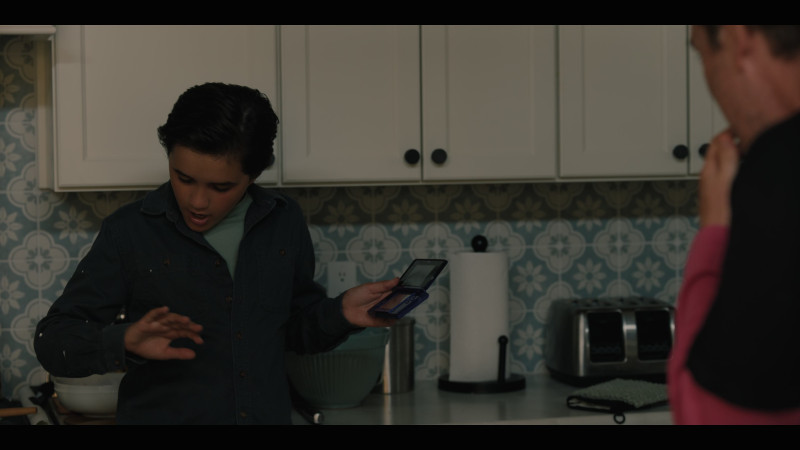 Nintendo DS handheld video game system in Good American Family S01E07 “If You Tell a Story Well Enough” (2025)