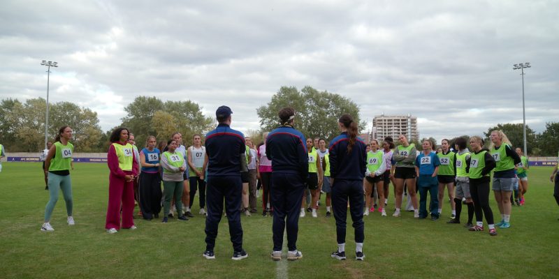 Hoka and Nike sneakers on the pitch